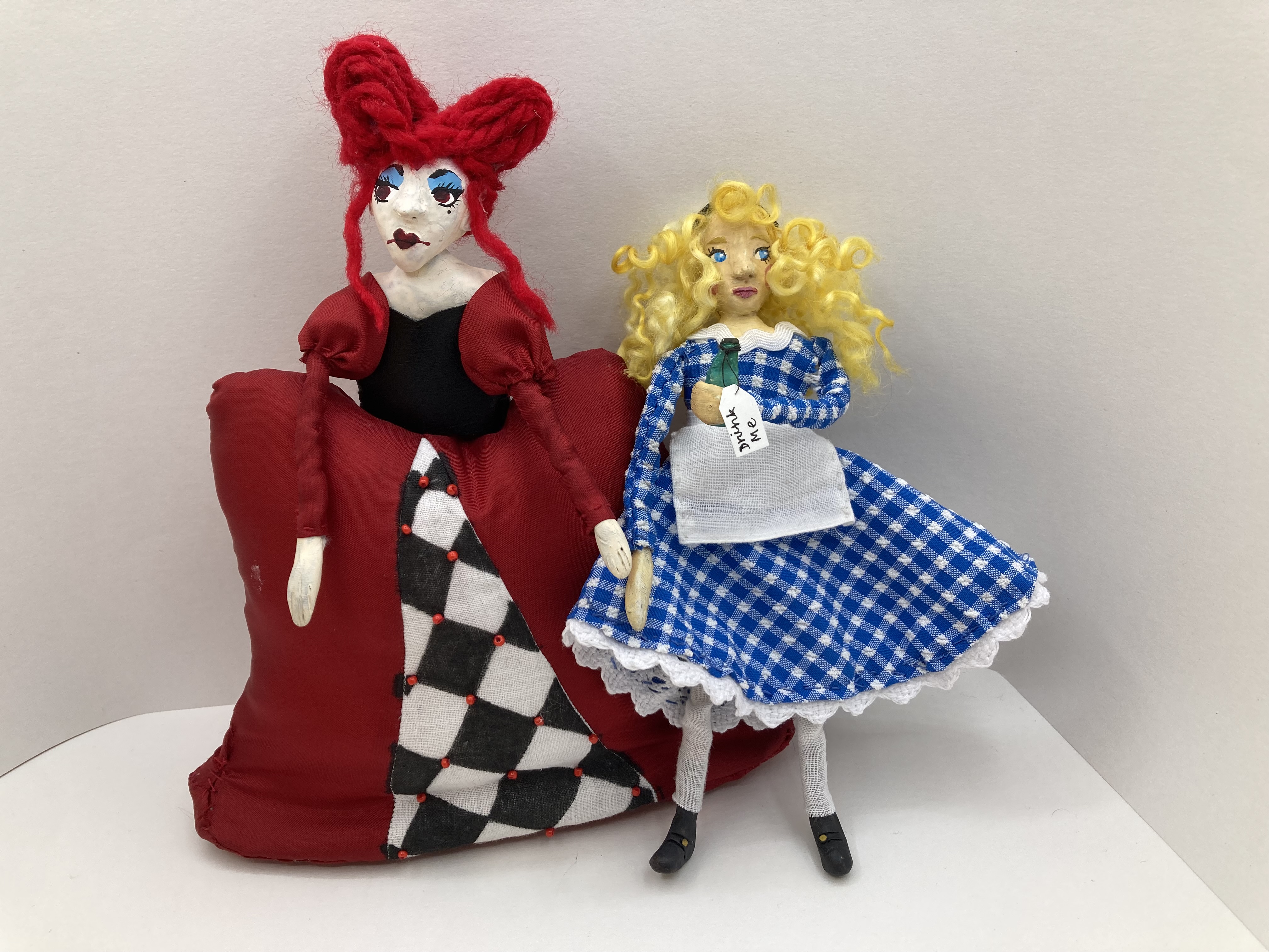 Handmade dolls of Alice and the Queen of Hearts.