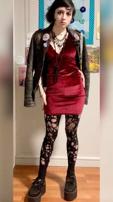 person in red velvet dress and leather jacket