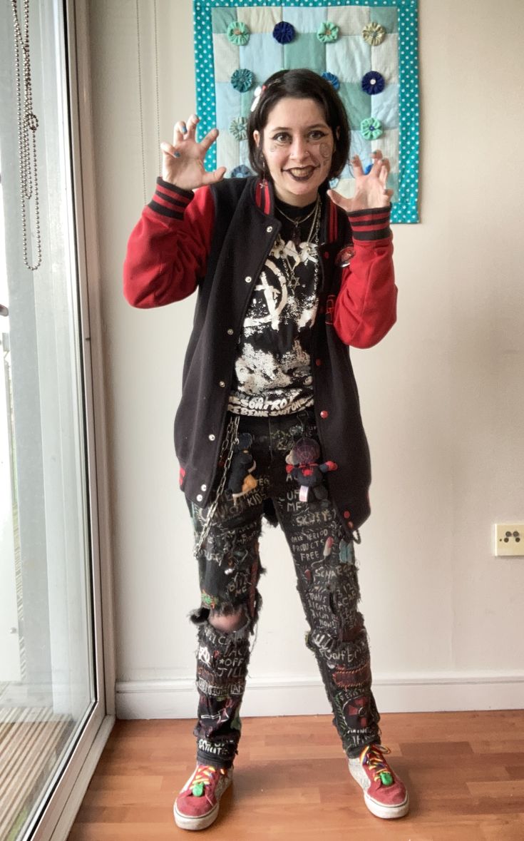 person in red jacket and black trousers and clown makeup.