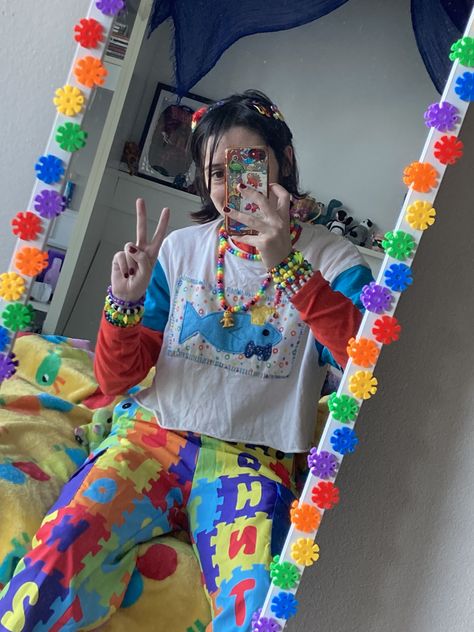 person in colourful outfit with fish on shirt