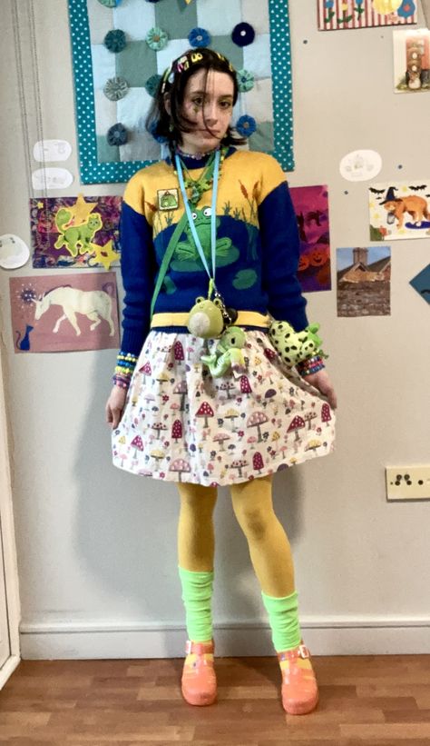 person in frog jumper and mushroom skirt