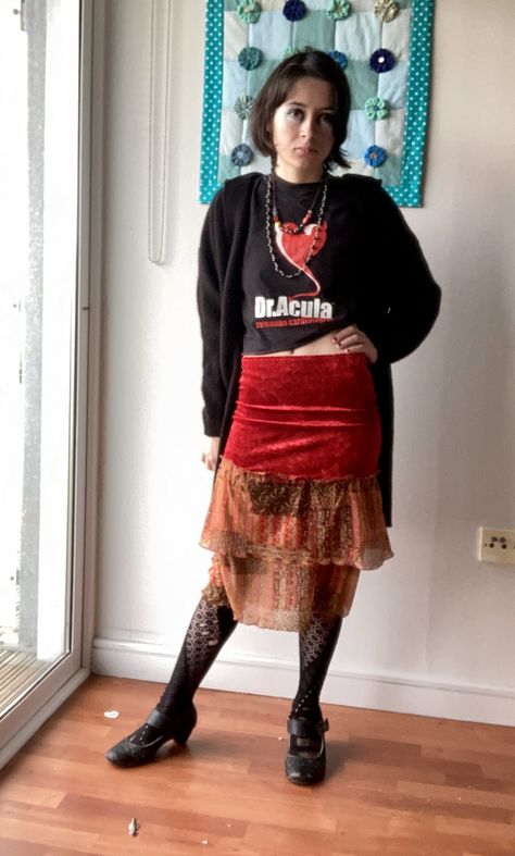 person in outfit with red skirt and vampire t-shirt